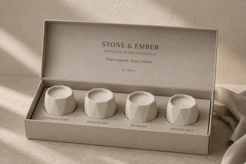 Discover South Australia pack with four cotton-wick candles in cream concrete vessels, presented in a single-row gift box. AI-assisted visual.