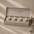 Discover South Australia pack with four cotton-wick candles in cream concrete vessels, presented in a single-row gift box. AI-assisted visual.